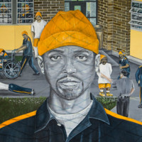 Color drawing of male prisoner in prison yard, with chain-link shadow across his face