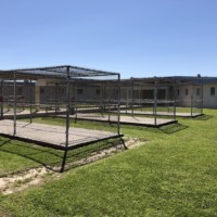 Several large cages in prison yard