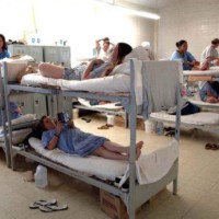 Several women prisoners in dorm bunk beds