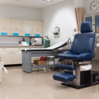 Infirmary room with examination table and examination chair